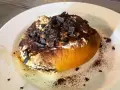 Un dolce al cucchiaio, forse un tiramisù rivisitato, con cacao e scaglie di cioccolato. Un'idea golosa su cosa mangiare a Roma.