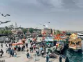 Un vivace mercato sul lungomare di Istanbul, con bancarelle di cibo, barche e la moschea sullo sfondo. Un momento perfetto per capire quando andare a Istanbul.