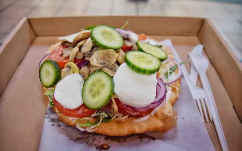 Lángos, un fritto ungherese con pomodoro, mozzarella, cetrioli e funghi. Un'ottima idea per cosa mangiare a Budapest.