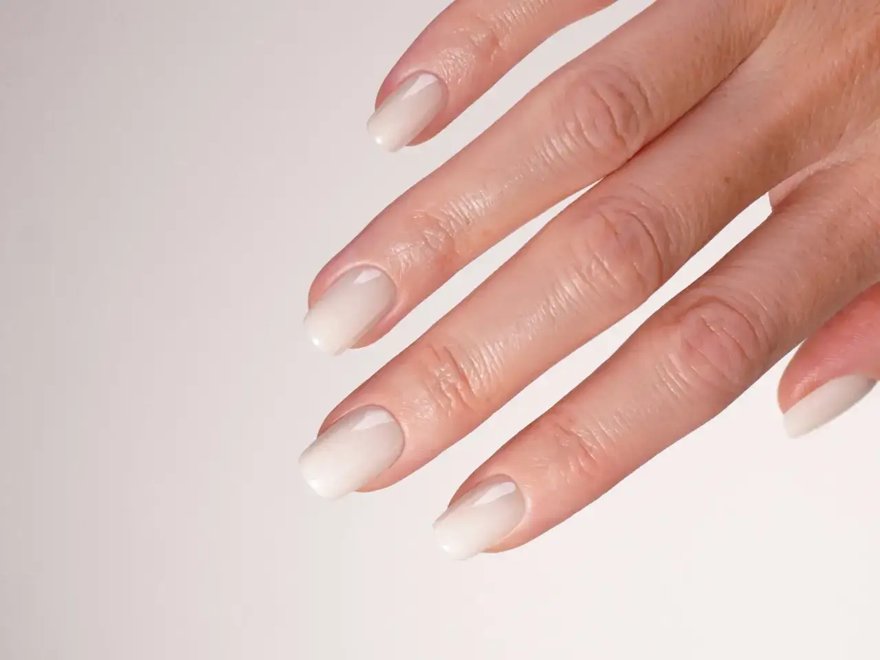 Mano con unghie gel effetto sposa french, un look particolare e raffinato per un giorno speciale.