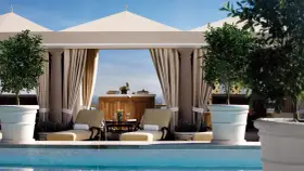 Rilassati in piscina a Los Angeles. Due lettini prendisole e alberi in vaso creano un'oasi perfetta per sapere dove dormire a Los Angeles.